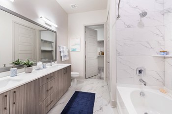 Primary bathroom with double sinks at Morea Apartments in Pompano Beach FL